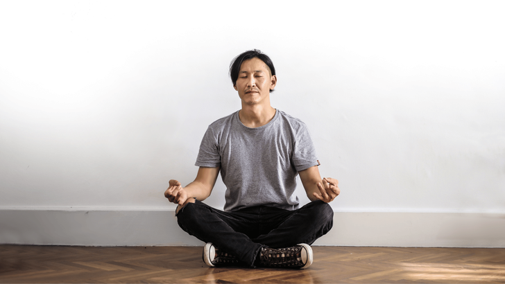 Man sitting on floor meditating