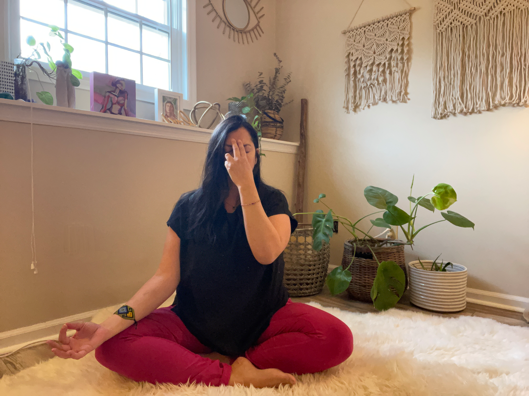 Woman practicing alternate nostril breathing